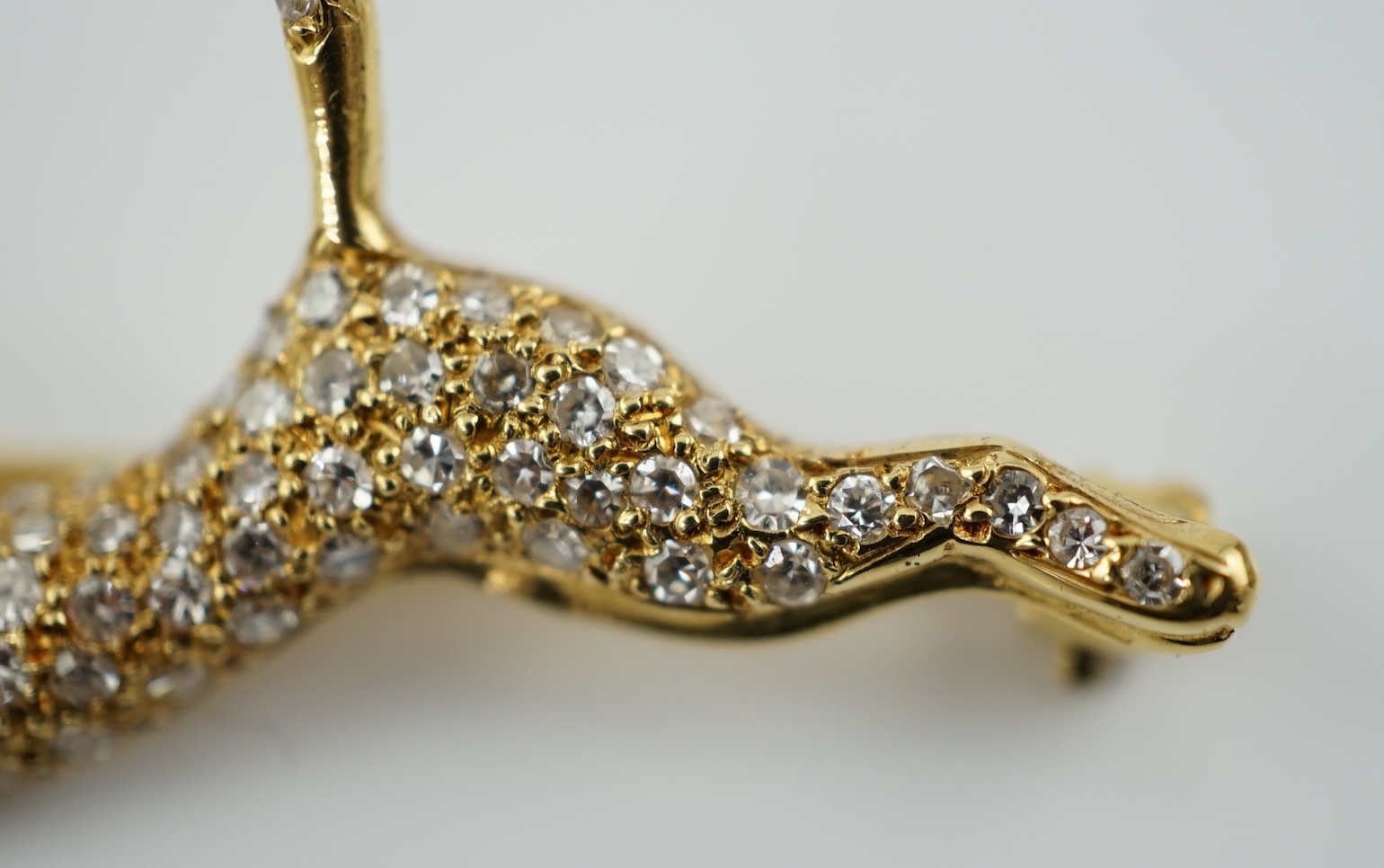 A gold and pave set diamond leaping panther brooch